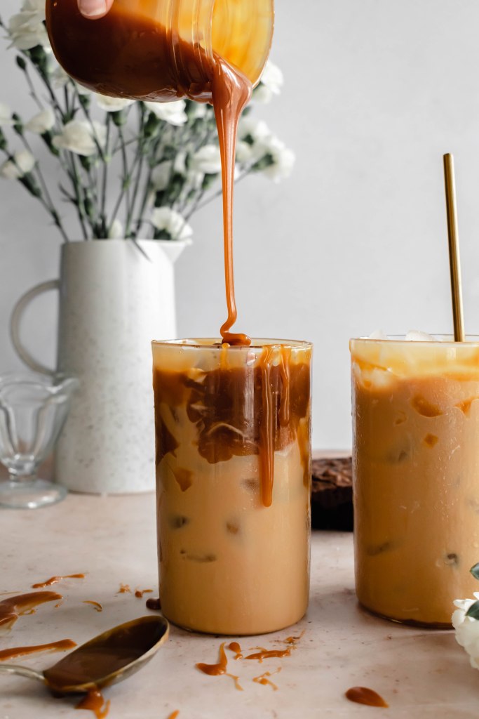 salted caramel sauce being poured in to an iced coffee