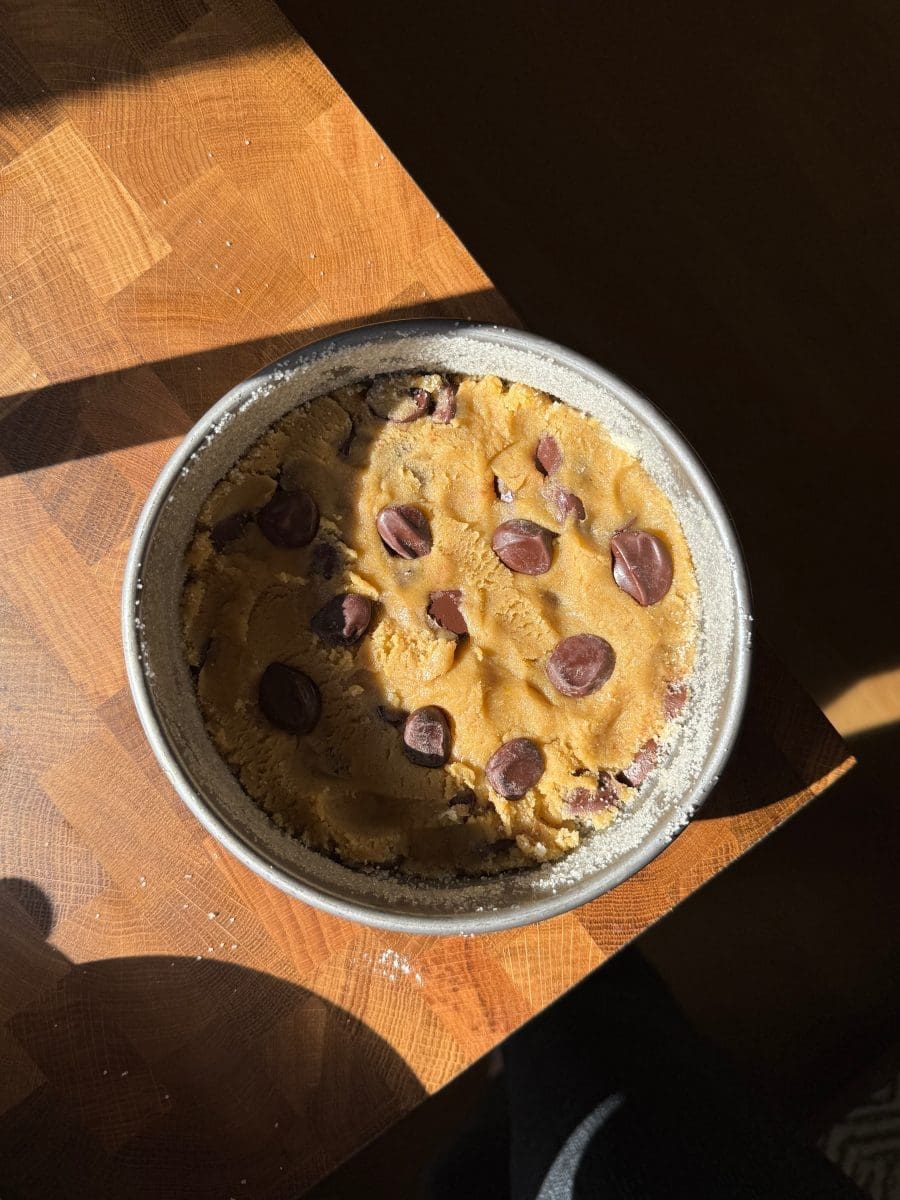 The cookie dough pressed into a cake pan.