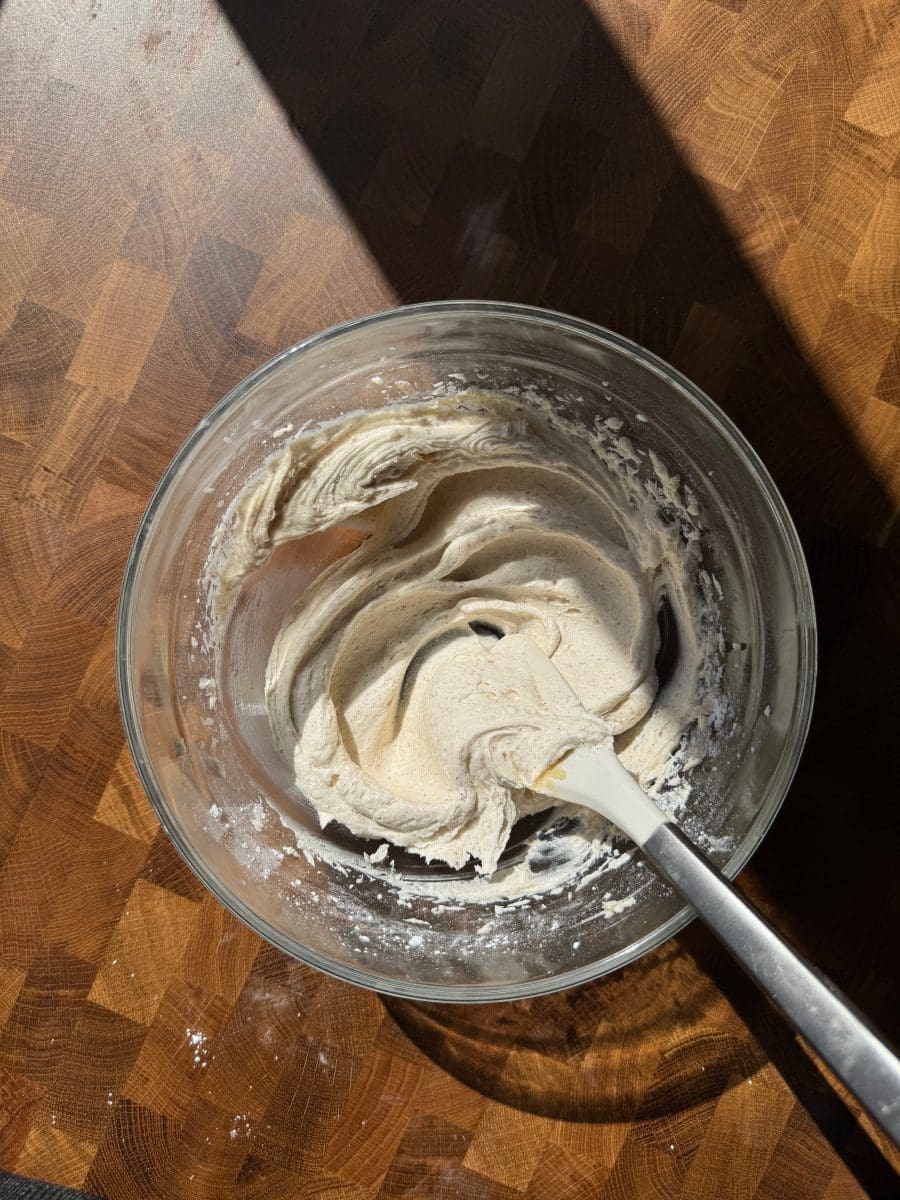 Brown butter frosting in a mixing bowl.