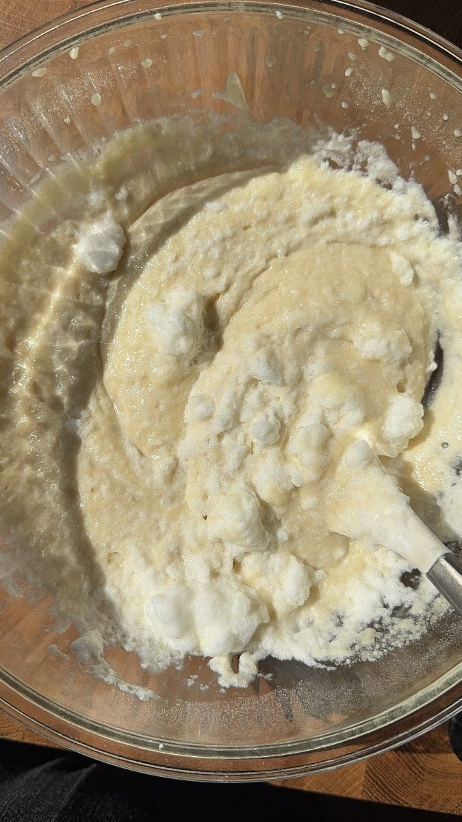 Folding egg whites into the batter.