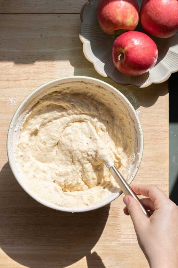 Folding flour into the cake batter.