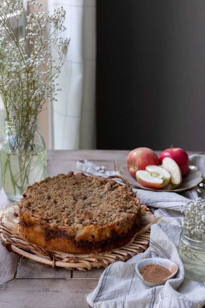 Overlooking the chai apple crumb cake stylized on a tray, before being sliced.