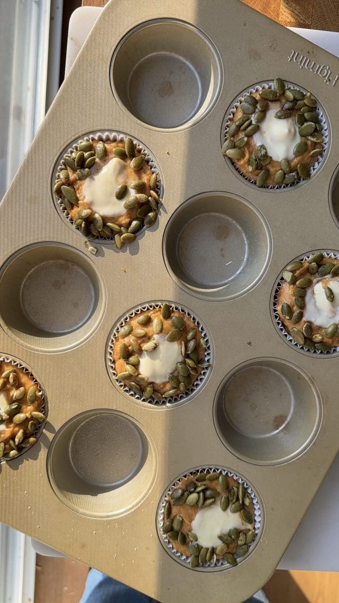 The pumpkin cheesecake muffins in a muffin tin before being baked.