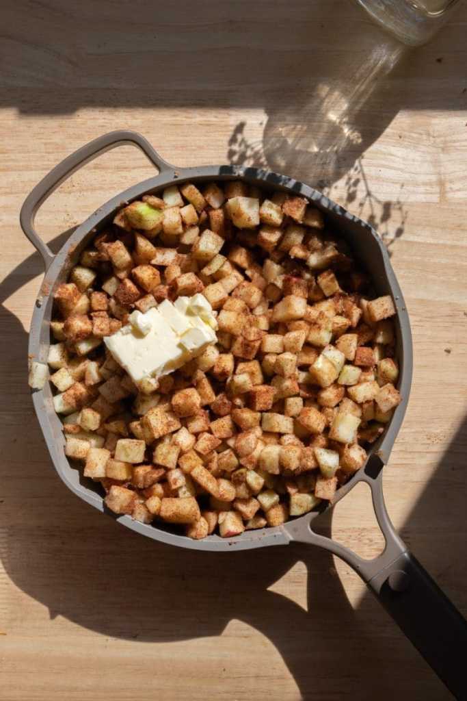 All of the apple pie filling ingredients in a saucepan.