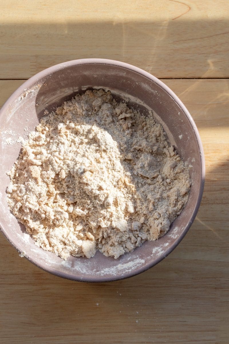 The dry ingredients and butter mixed together in a mixing bowl.