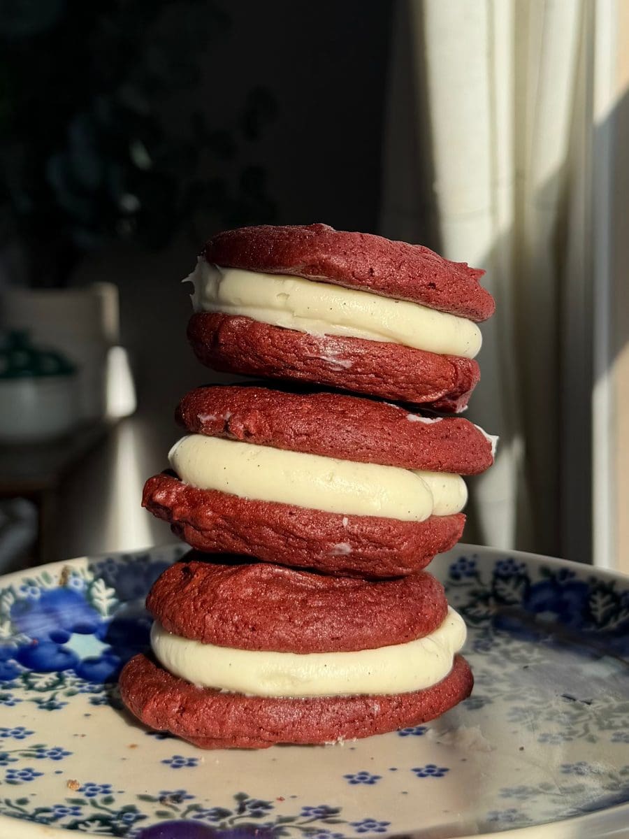 The red velvet brownie cookie sandwiches stacked on top of each other.