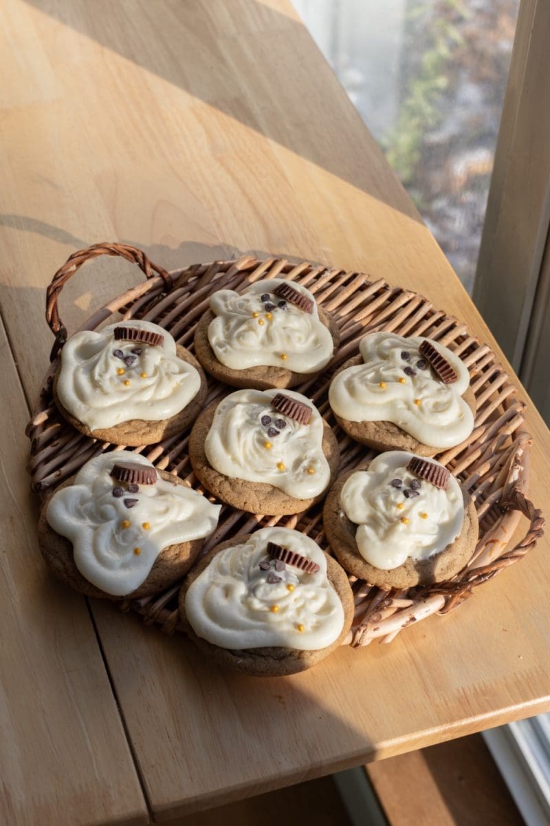 Angled view of the melting snowman cookies on a tray.
