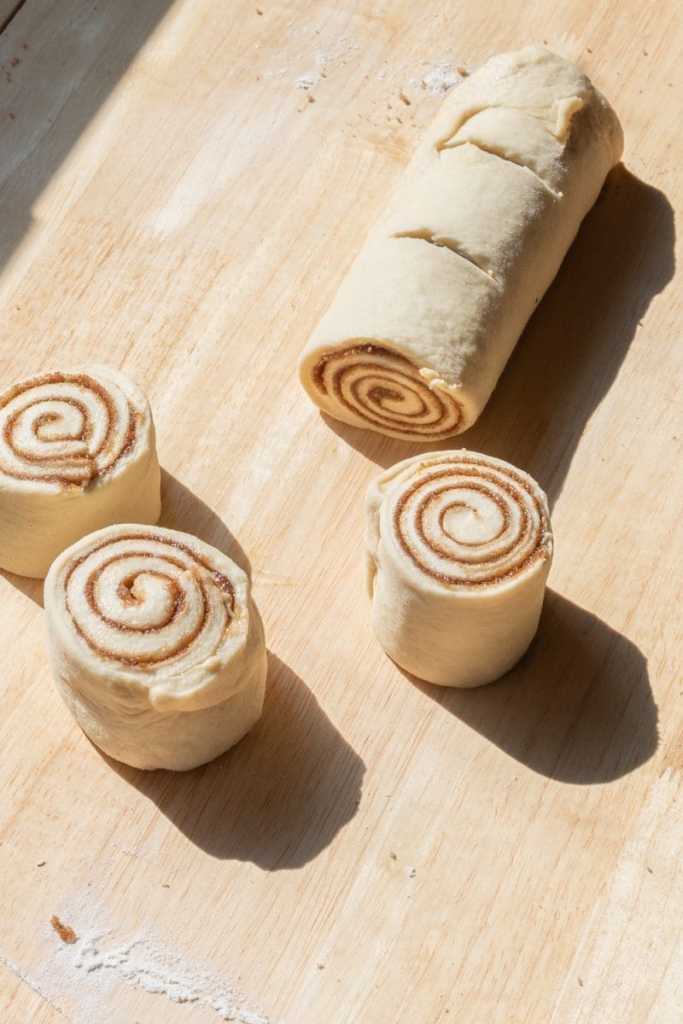 Slicing the dough log into pieces.