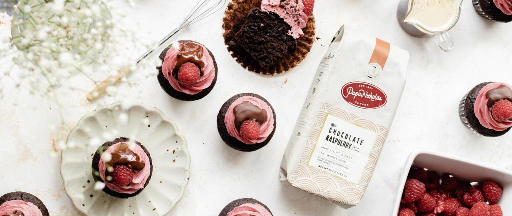 Banner of the chocolate raspberry cupcakes next to a bag of PapaNicholas coffee.