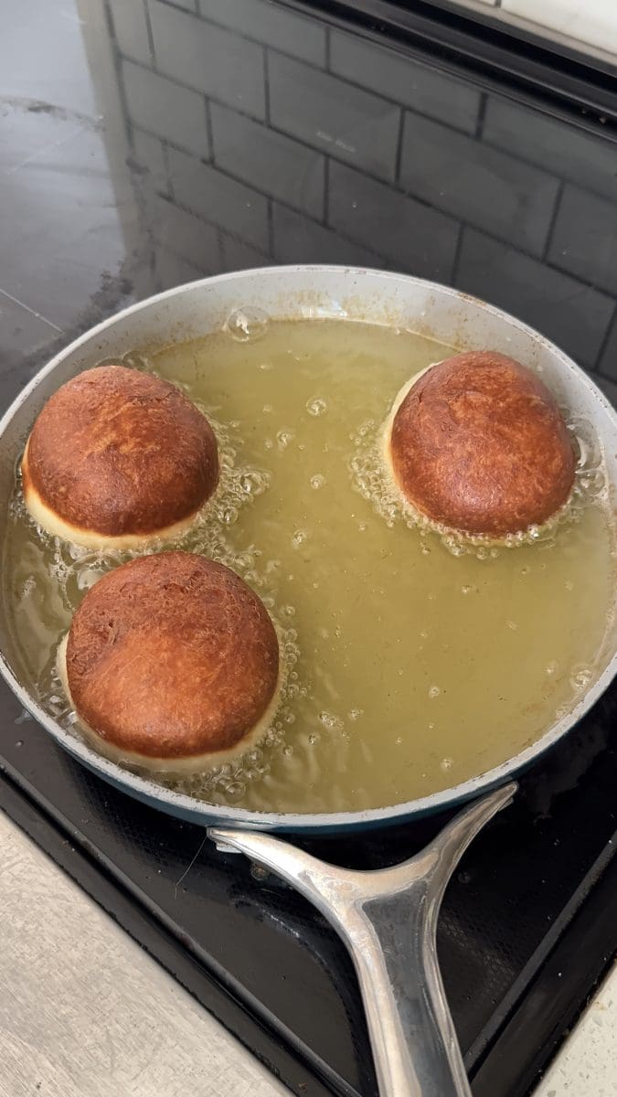 Frying the donuts.