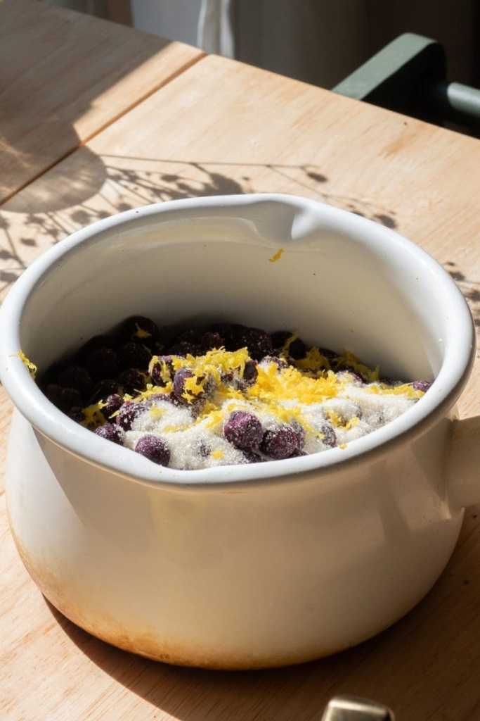 The blueberries, sugar and lemon zest in a saucepan.