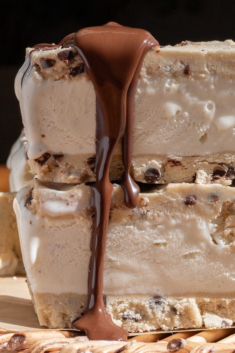 Close up of the cookie dough ice cream sandwiches with a chocolate drizzle.