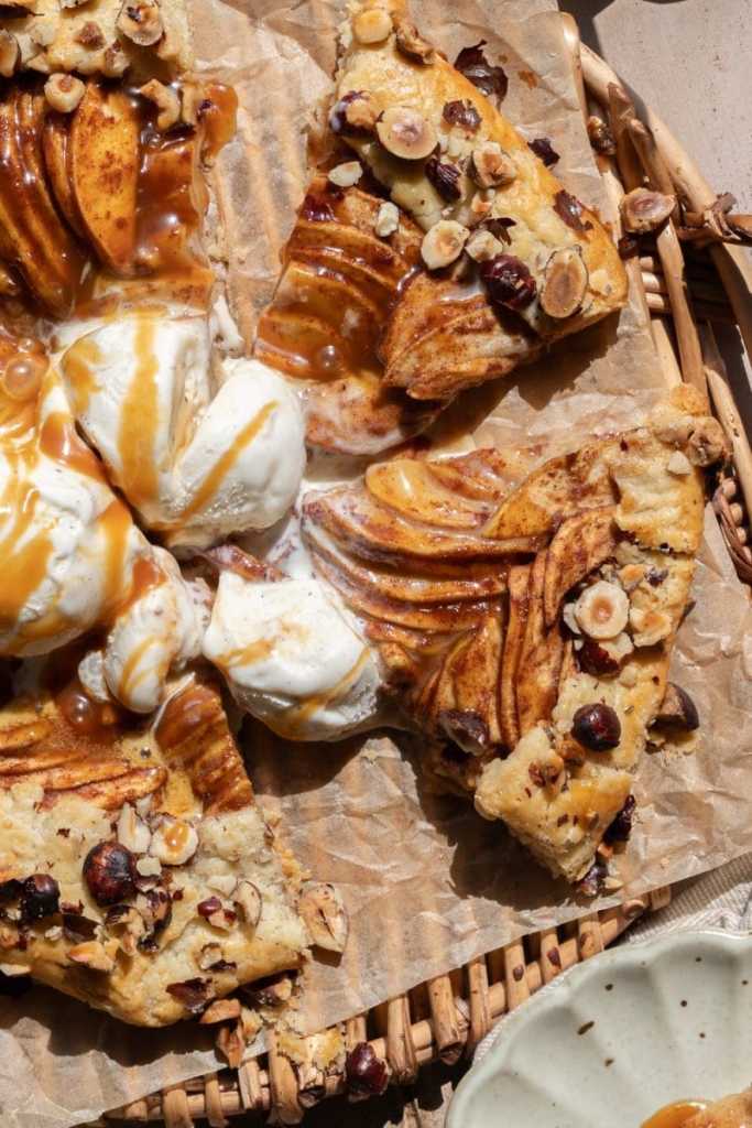 Close up of the sliced salted caramel apple galette topped with ice cream.