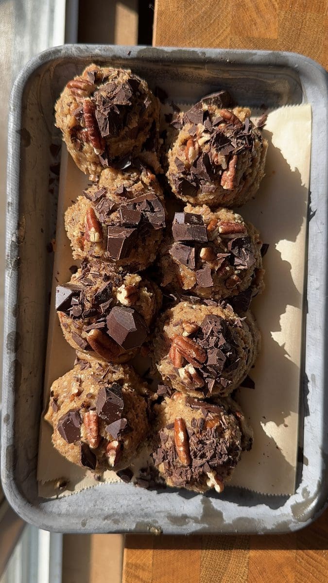 The cookie dough scooped out onto a baking tray.