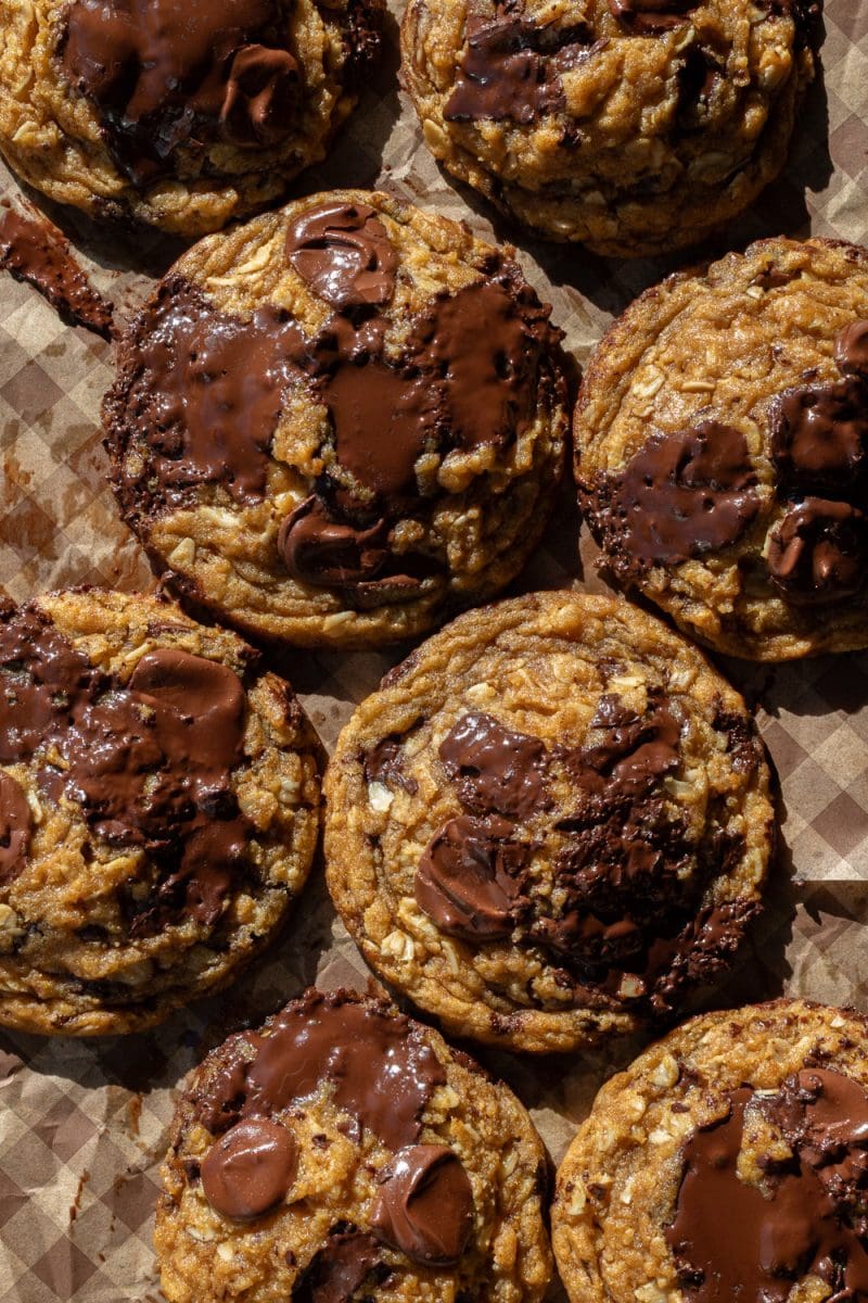 The pumpkin oatmeal chocolate chip cookies on a parchment lined baking tray.