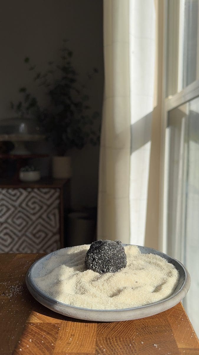 Rolling the cookies in sugar.