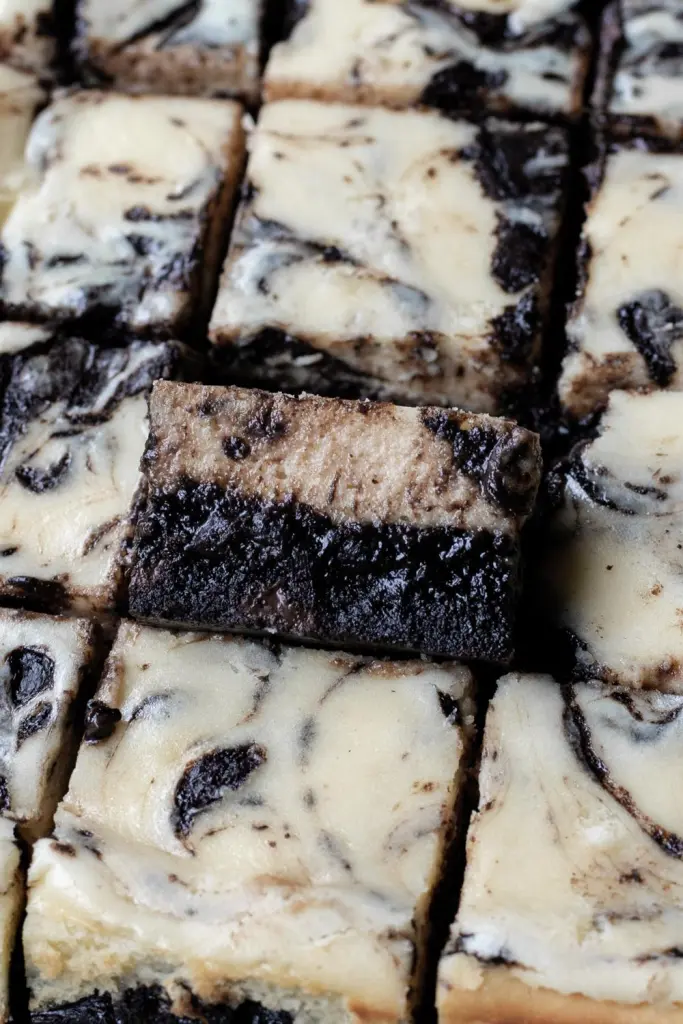 a close up of the cross section of the dark chocolate cheesecake brownies