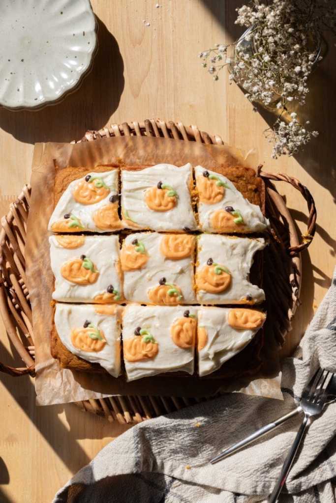 Overhead view of the frosted pumpkin spice sheet cake on a serving tray.