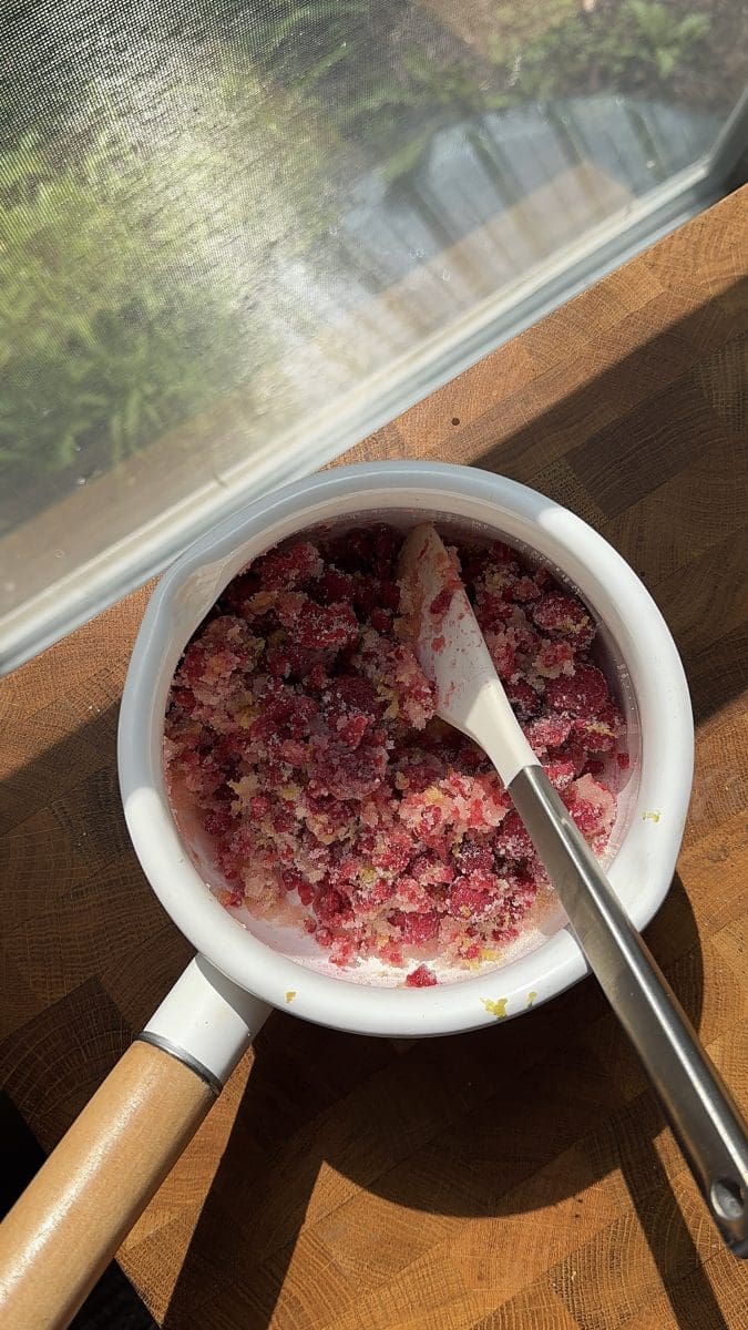 The raspberry curd ingredients in a saucepan.