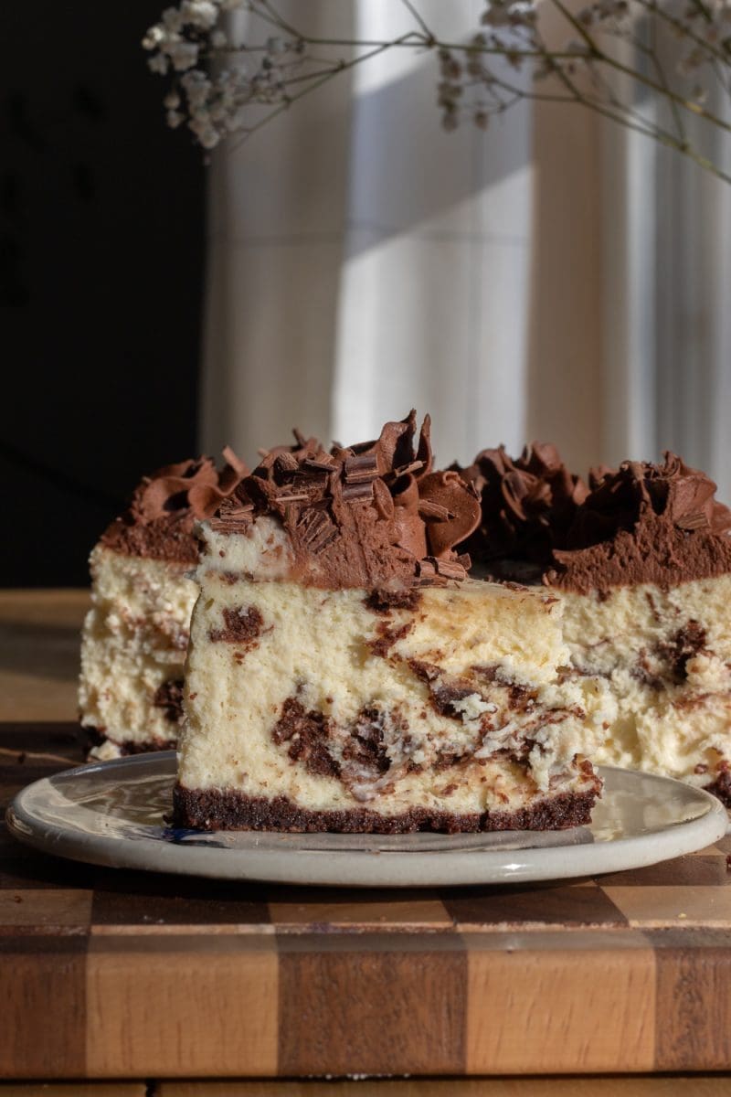 Close up of a slice of brownie cheesecake.