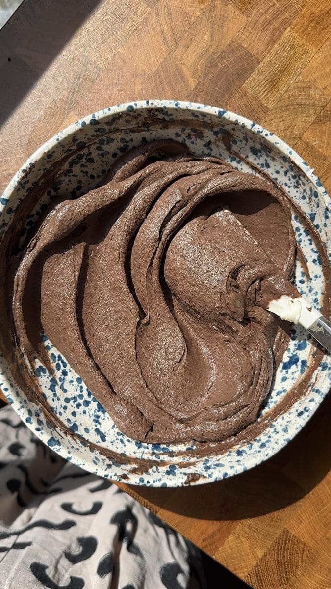 The chocolate frosting in a mixing bowl.