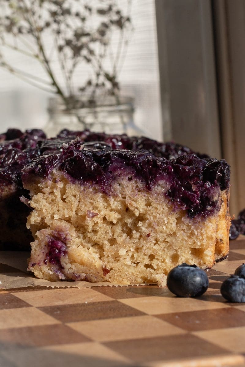 Close up of a slice of the banana blueberry upside down cake.