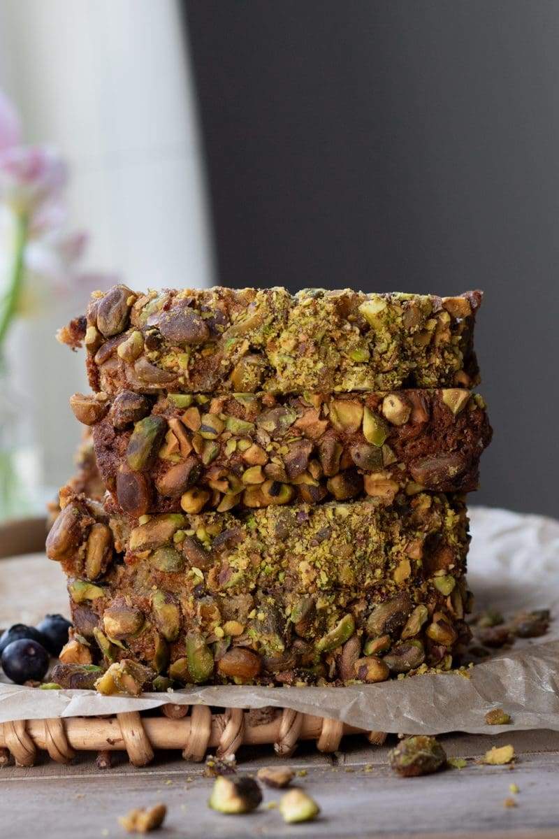 A view of the pistachio crust, with four slices of the blueberry banana bread stacked on top of each other.