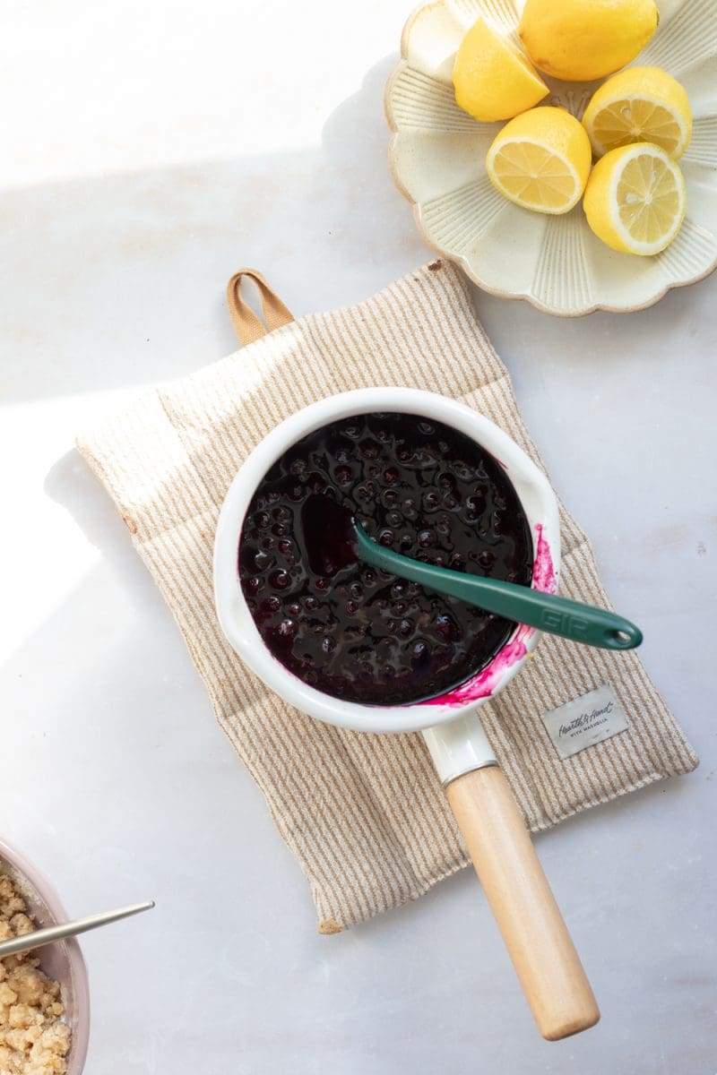 The wild blueberry jam in a saucepan.