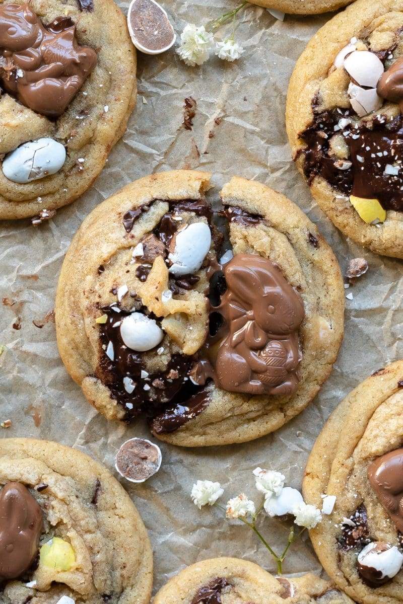 a cadbury egg cookie broken in half, showing the melty chocolate.