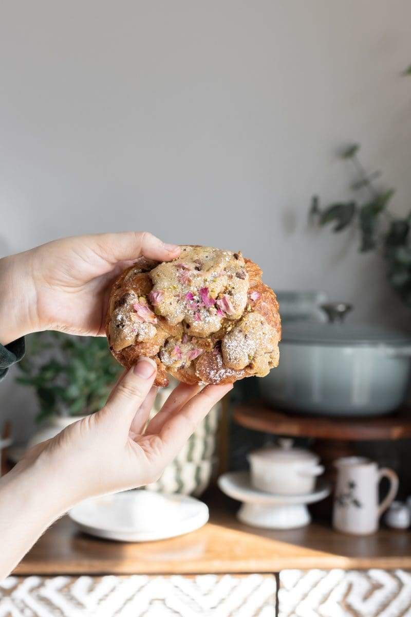 holding up one of the cookie croissants to the camera