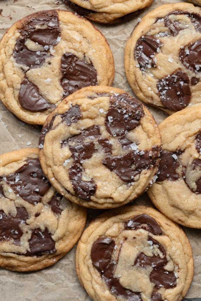 Close up of the small batch chocolate chip cookies on a tray with parchment paper.