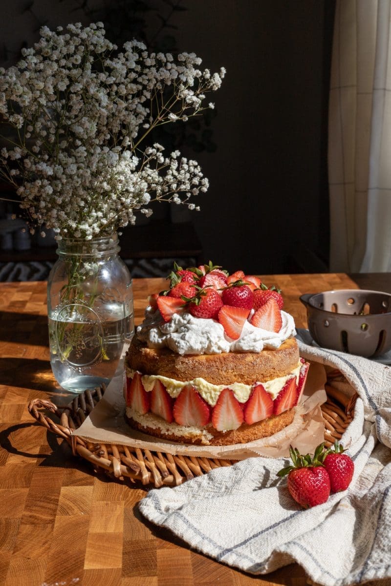 Strawberries and cream cake on a serving tray.