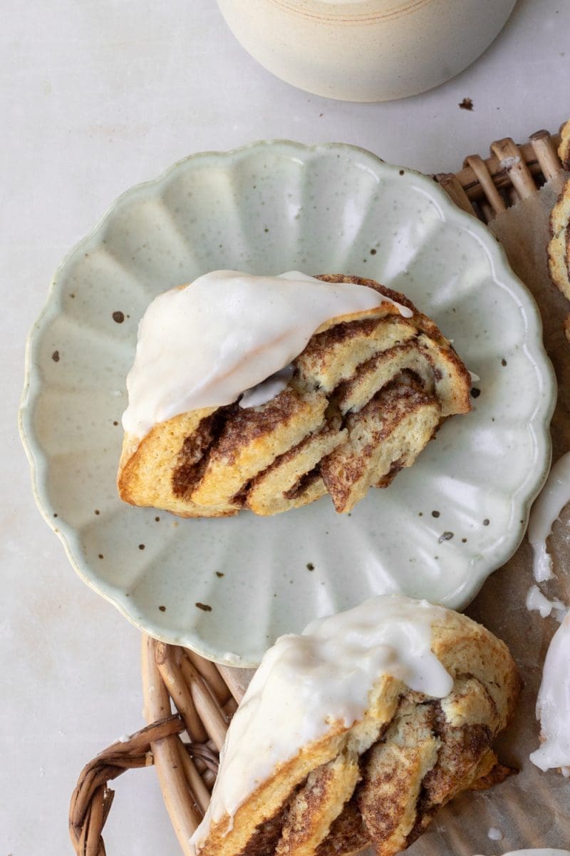 Close up of a cinnamon roll scone on a plate.