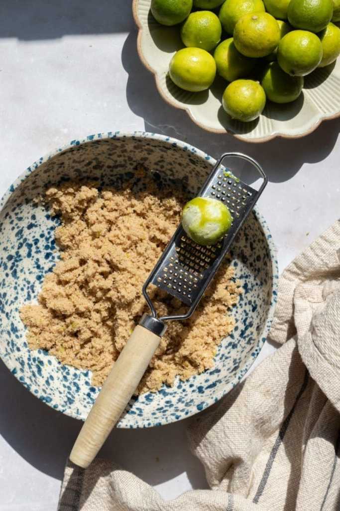 Zesting the key limes into the sugar.