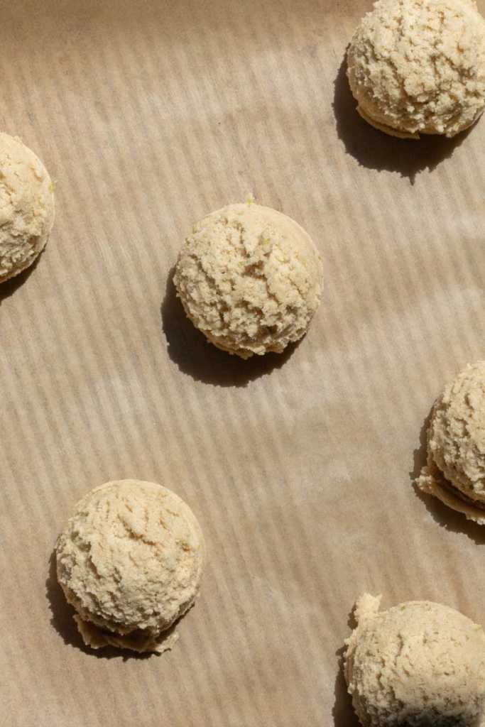 The cookie dough balls spaced out on a baking sheet.