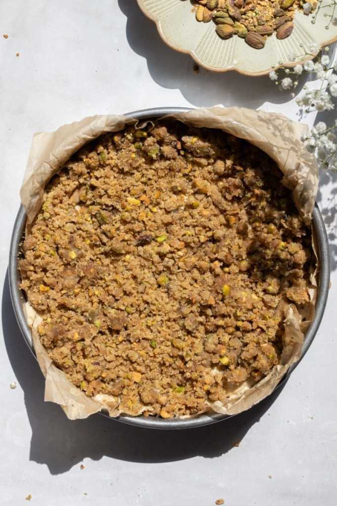 Layering the streusel on to the coffee cake batter.