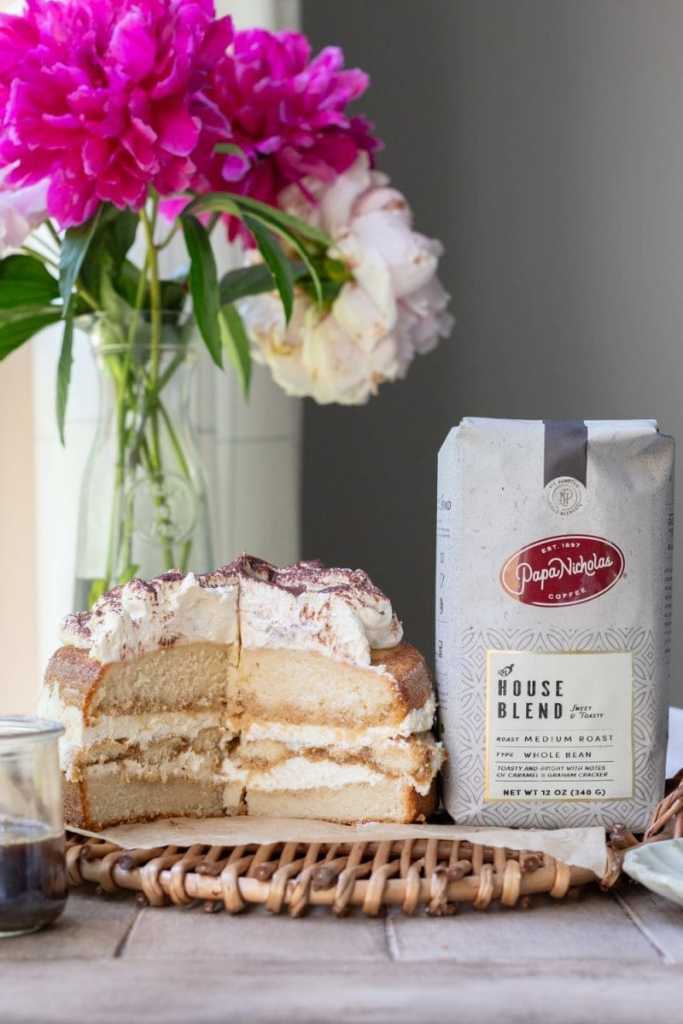 The tiramisu cake next to a bag of coffee.