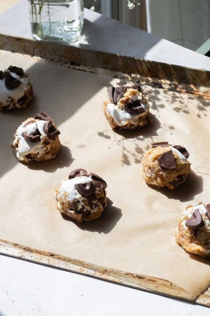 The cookie dough balls on a baking tray.