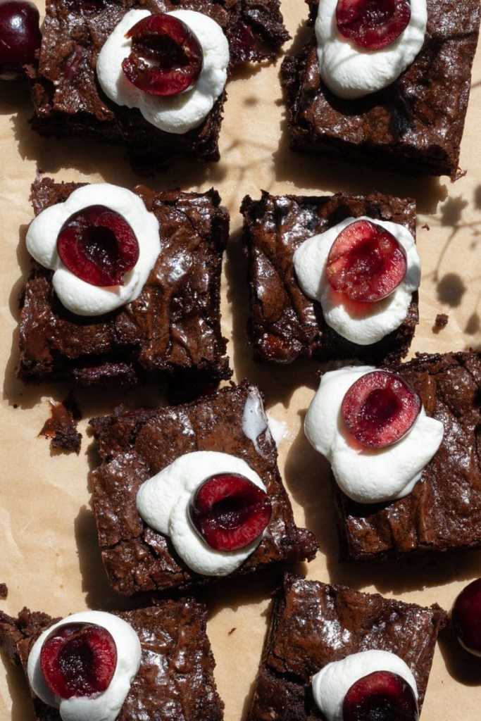Flat lay of the sliced and topped black forest brownies