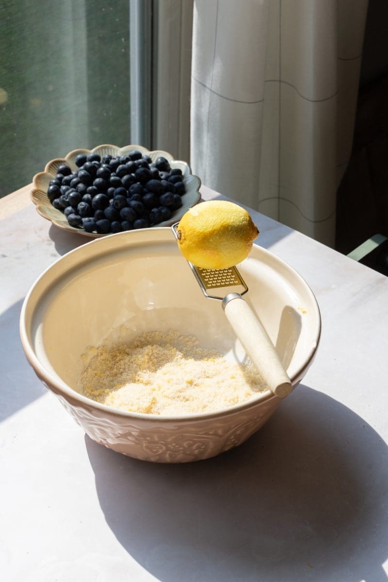 Zesting the lemon into the sugar.