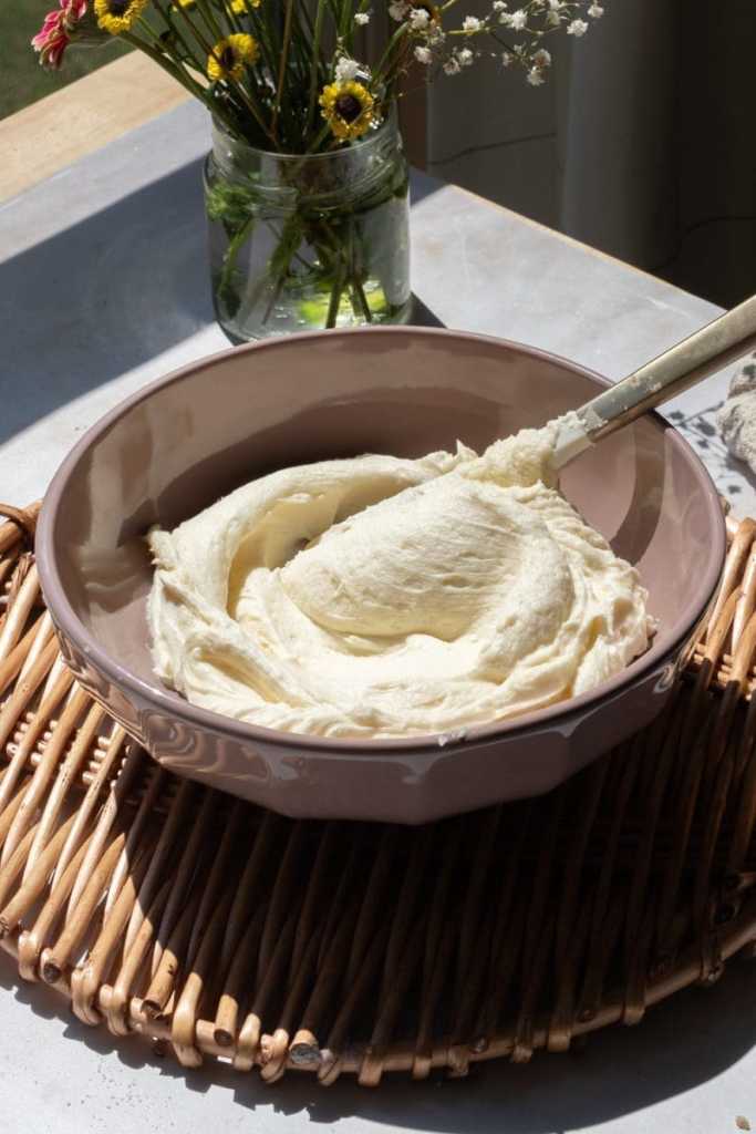 The whipped buttercream frosting in a mixing bowl.
