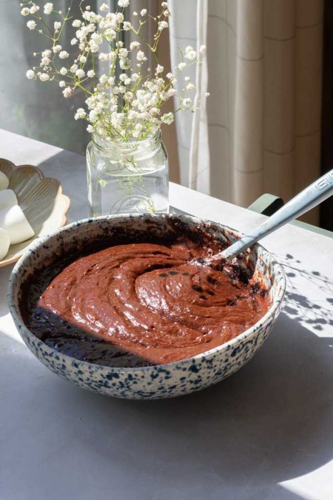 The finished brownie batter in a mixing bowl.