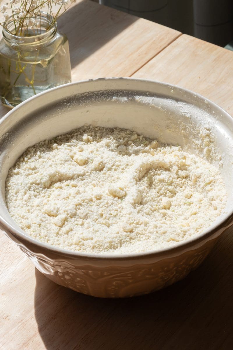 A mixing bowl with the dry ingredients and butter beaten together in it.