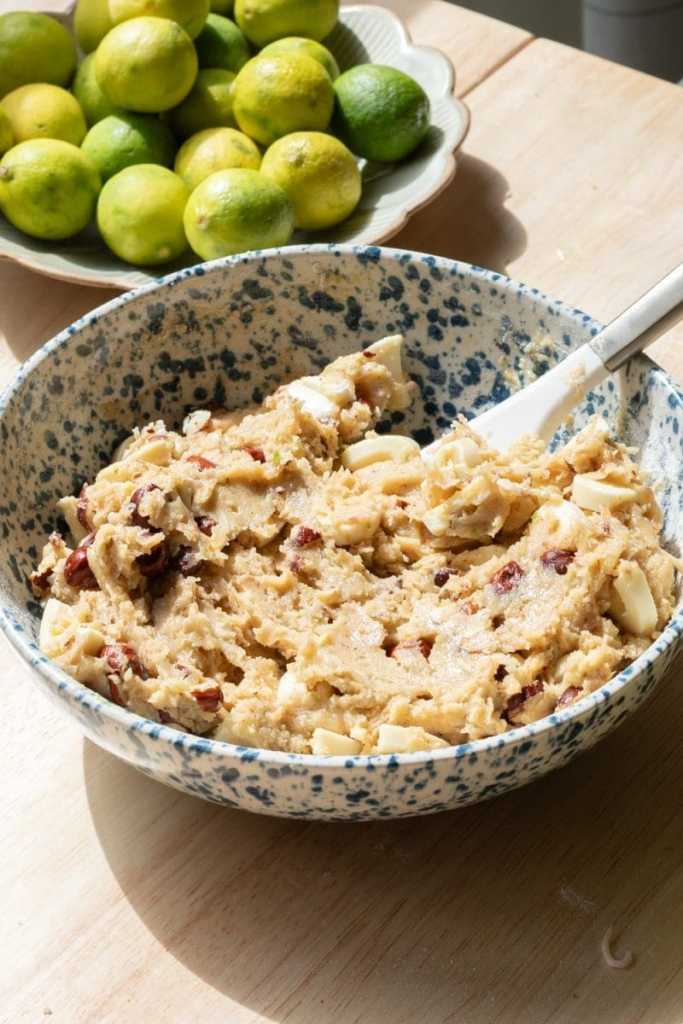 The key lime white chocolate chip cookie dough in a mixing bowl.