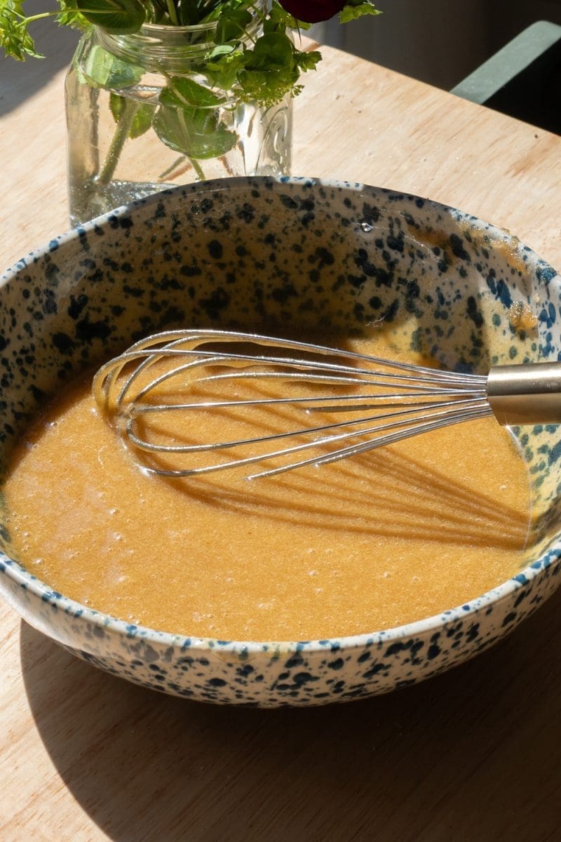 All the wet ingredients mixed together in a mixing bowl.