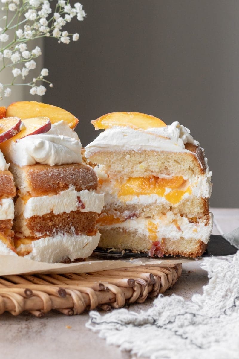 Close up of a slice of peaches and cream cake.