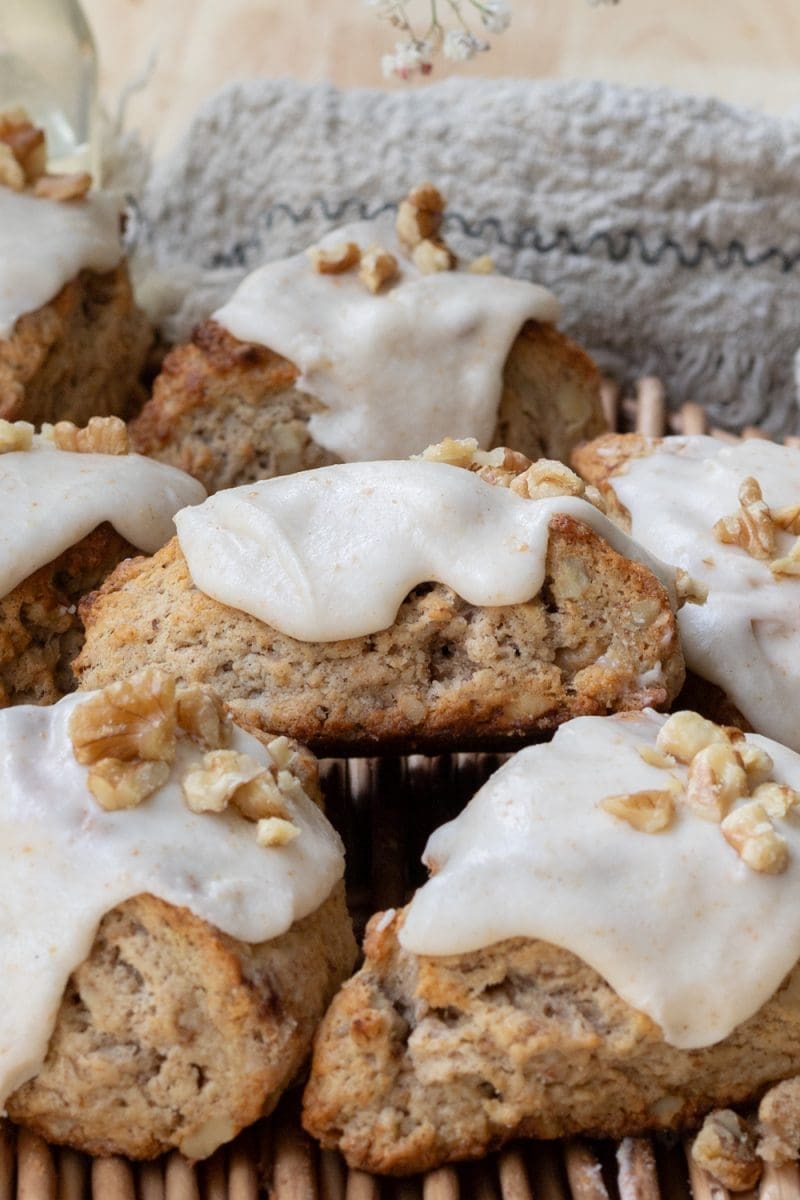 Close up of a banana bread scone on top of a pile of scones.