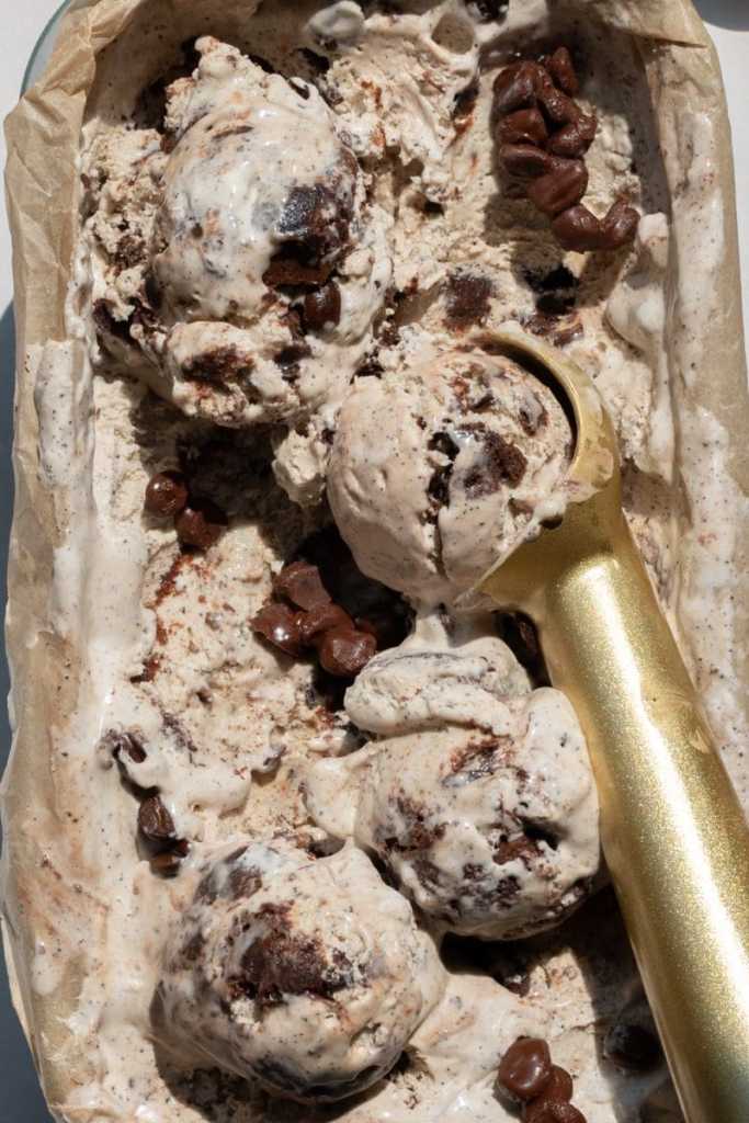 Close up of the no-churn coffee ice cream with scoops of the ice cream on top of it.