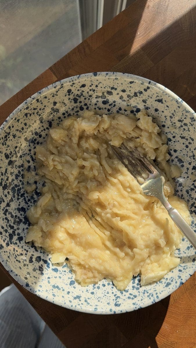 The mashed banana in a mixing bowl.