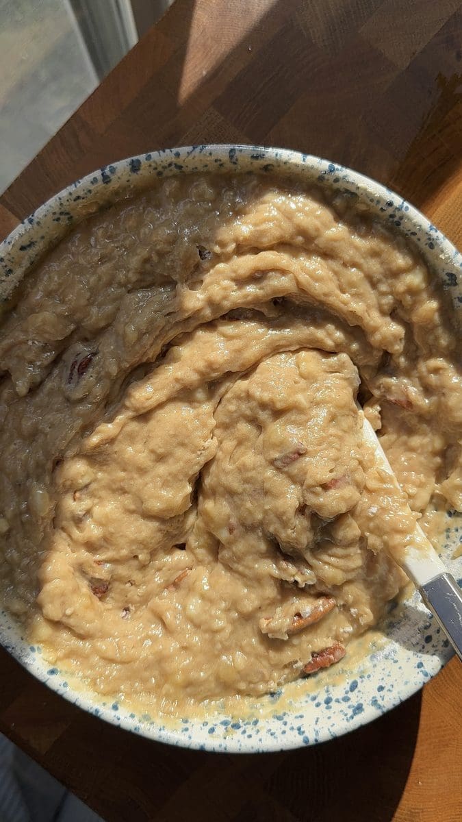 The finished banana cake batter in a mixing bowl.